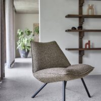Axium FR recycled-content flame-retardant upholstery fabric in interior — acrylic / recycled polyester / recycled olefin blend, sustainability-positioned. Lifestyle view 1.