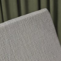 Cassia FR upholstery fabric in interior — recycled olefin / polyester / PAN blend, boucle texture, UV-stable. Lifestyle view 6.