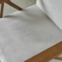 Cenia FR patterned upholstery fabric in interior — polyester / acrylic / viscose blend, large pattern repeat. Lifestyle view 5.